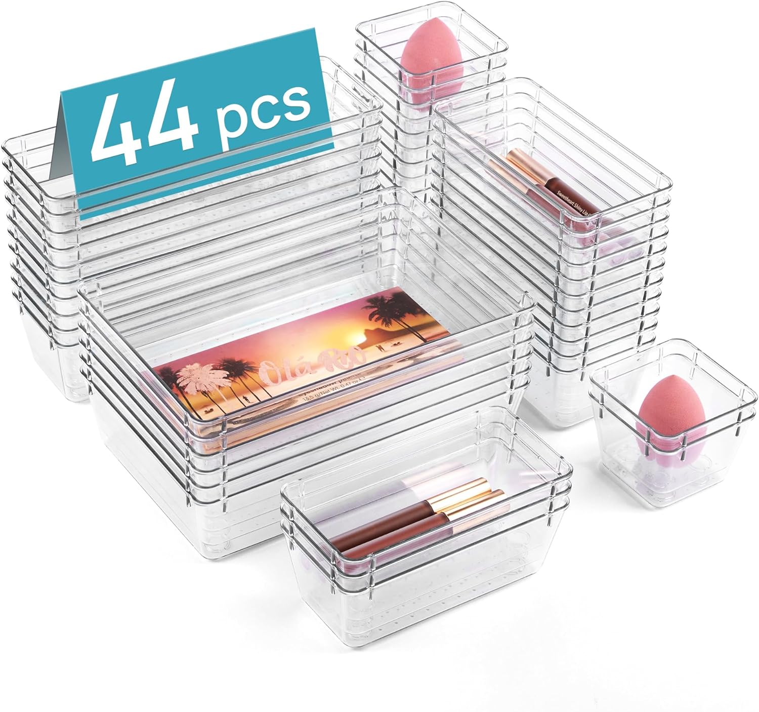 Multiple clear plastic organizer trays of different sizes arranged neatly in a drawer, holding various small items sorted by category